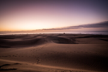 Fototapeta na wymiar Spectacular Sunrise Sandy dunes in famous natural Maspalomas beach. Gran Canaria. Spain