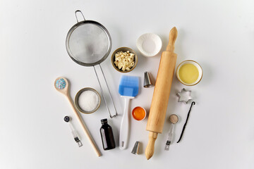 Fototapeta na wymiar food, culinary and recipe concept - cooking ingredients and kitchen tools for baking on table