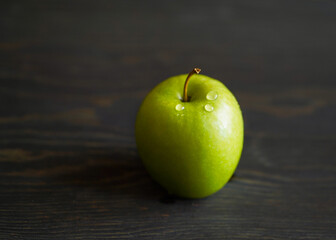 green apple on a wooden table