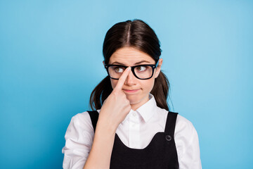 Close-up portrait of her she nice attractive lovely brainy boring dull brunette schoolgirl nerd geek fixing specs learning subject isolated over bright vivid shine vibrant blue color background