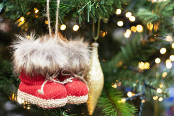 Christmas tree decorated with Christmas toy shoes. Decorated Christmas fir tree.