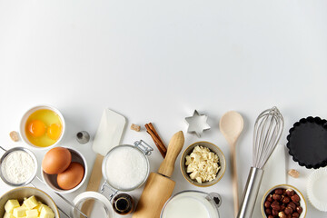 food, culinary and recipe concept - cooking ingredients and kitchen tools for baking on table