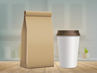 Paper bag and a mug with fresh coffee on wooden table.