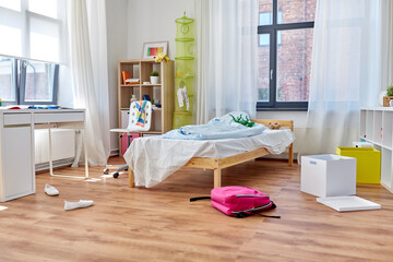 mess, disorder and interior concept - view of messy home kid's room with scattered stuff