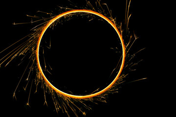 Ring made of sparklers on a black background.