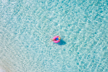 Top above high angle aerial drone view of her she attractive girl floating on rubber ring in ocean pure water enjoy leisure dream voyage weekend sunny day weather pleasure