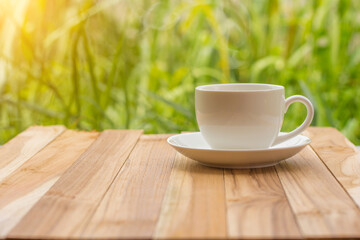 Coffee espresso on wood table nature background in garden,warm tone