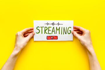 Live streaming web network concept. Female hands holding paper tablet. Top view