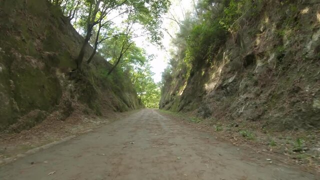 Point of view shot of riding a bicycle at Amarante Cycling Trail in Portugal. Features a wide view of the bike track and the natural scenery as it travels.