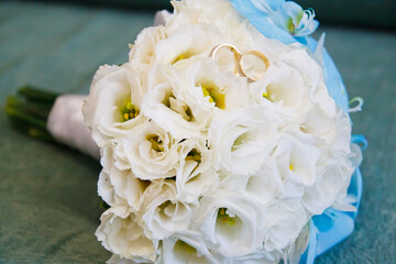bright wedding bouquet of summer flowers  with wedding rings