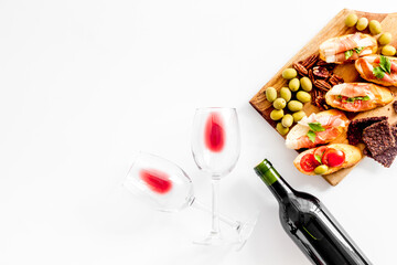 Bruschetta with prosciutto and red wine in glasses from above copy space