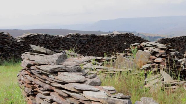 Old Construction Located In The Middle Of A Field Of Grass, With Impressive Stone Walls That Have Lasted For A Long Time