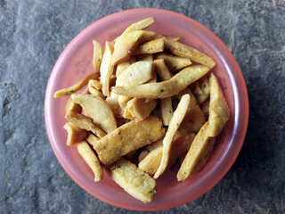 some yellow fresh eatable food put in a bowl on stone background