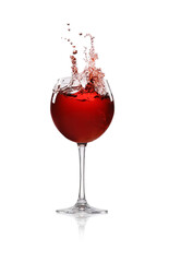 Red wine splashing in glass on white background
