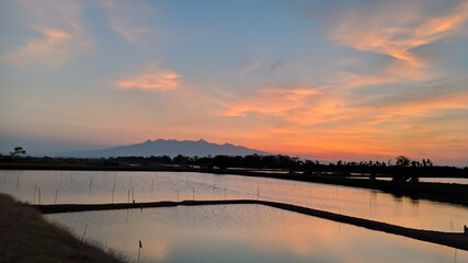 The sun sets over the ponds and beautiful sky