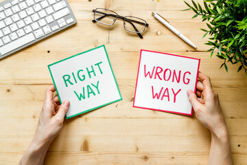 Making desicion concept. Right and wrong way icons, female hands top view