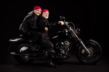 Fototapeta na wymiar Full size profile photo of aged bikers grey hair man lady married couple drive speed vintage chopper traveling together feel young wear rocker leather outfit isolated black color background