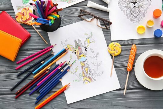 Composition with coloring pictures on table