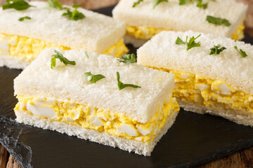 Japanese egg sandwiches close-up on a slate board on the table. horizontal