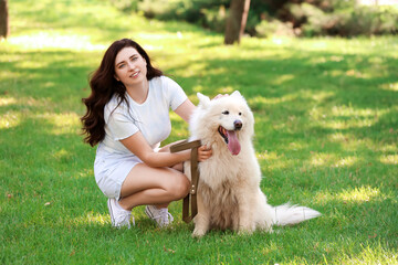 Young woman with cute dog in park