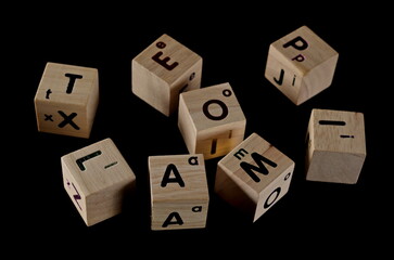 Wooden building alphabet letter blocks for kids isolated on black background