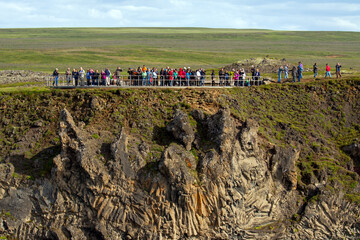 Many tourists looking at Godafoss waterfall in northern Iceland, low view