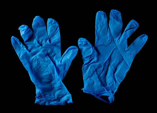 Blue surgical latex gloves pair isolated on black background, top view