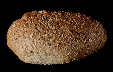 Integral rye bread loaf with sesame seeds isolated on black background with clipping path
