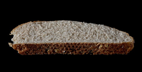 Integral rye bread slice with sesame seeds isolated on black background with clipping path
