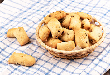 Freshly baked homemade raisin cookies on a towel.