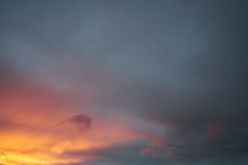 Fototapeta na wymiar Orange and teal cloudy sky at sunset