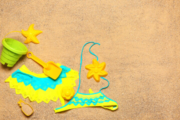 Fototapeta na wymiar Set of beach accessories for children on sand, top view