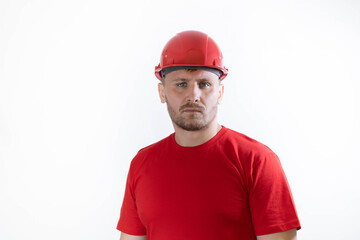 A man in a construction helmet and a red T-shirt.