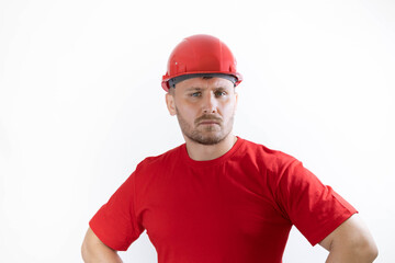 A man in a construction helmet and a red T-shirt.