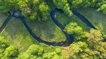 Drone shot of natual river during summer with canoeing peoples