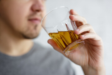 close up of young man drinking whiskey