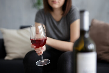 glass of red wine in female hands