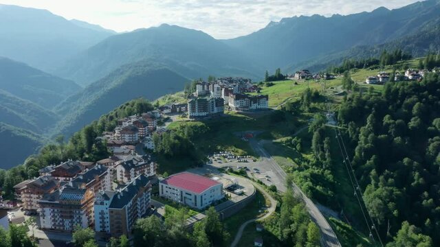 Roza Khutor plateau, buildings, slopes and chair lifts. Aerial view at summer. Russia, Sochi, Krasnaya Polyana