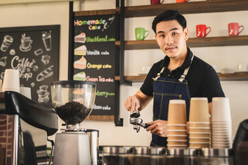 The young barista is determined to make coffee meticulously.