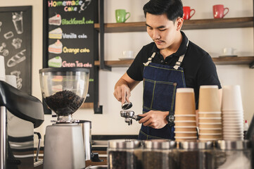 The young barista is determined to make coffee meticulously.