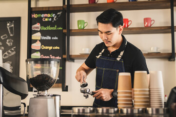 The young barista is determined to make coffee meticulously.