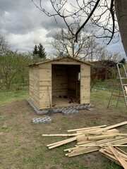 wooden house shed building in progress in garden