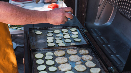 Hand pouring salt on vegetarian barbecue