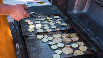 Hand holding tongs to move food