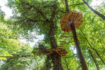 View of the adventure park with obstacles on the trees. Forest barriers to family satisfaction....