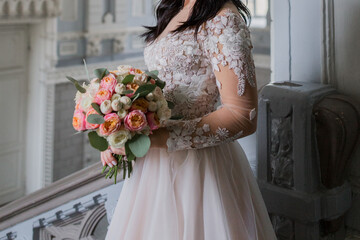 bride with a bouquet in an old building