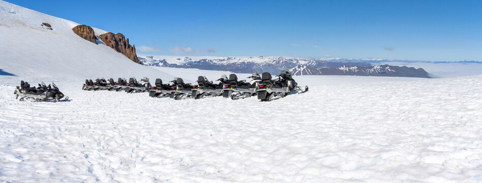 JOKLASELL, ICELAND: snowmobiles parked at Vatnajokull glacier, South-eastern Iceland, on a cloudless day in summer.