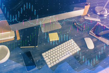 Double exposure of forex graph and work space with computer. Concept of international online trading.