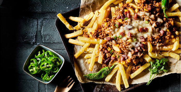 Close up on savory mince, cheese and potato fries