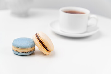 macarons on background tea Cup on a white table